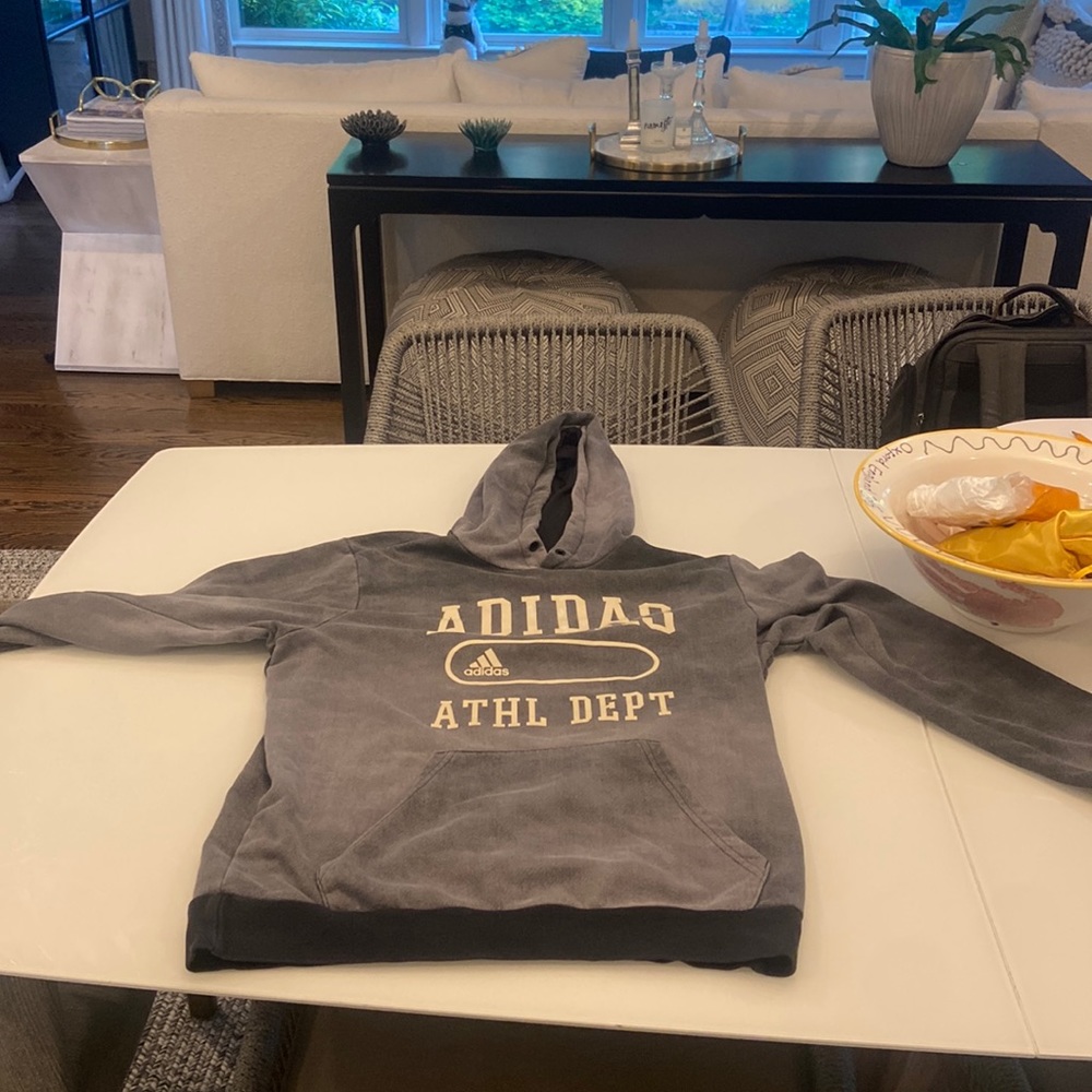 I am selling a dark grey Adidas sweatshirt.